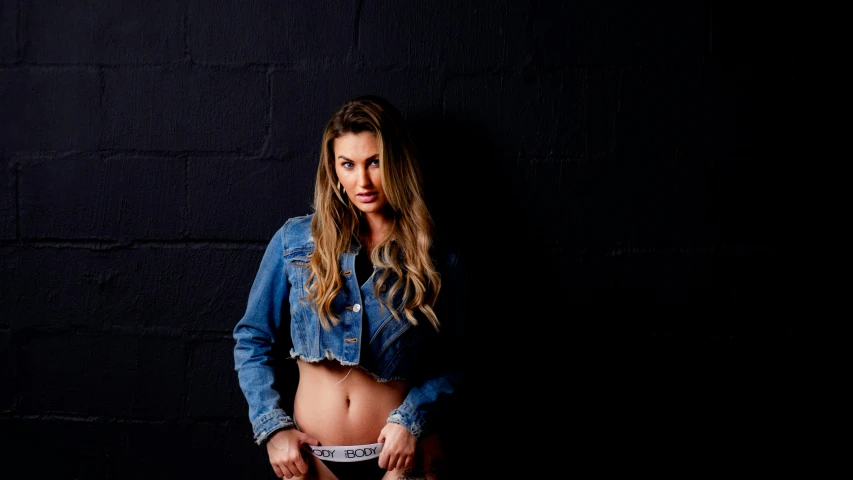 a woman in a jean shirt posing for the camera