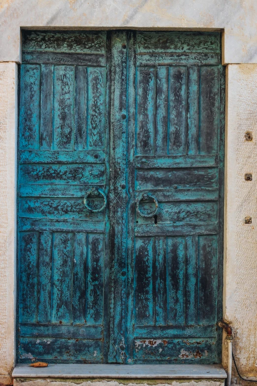 an open green door is seen in front of a building