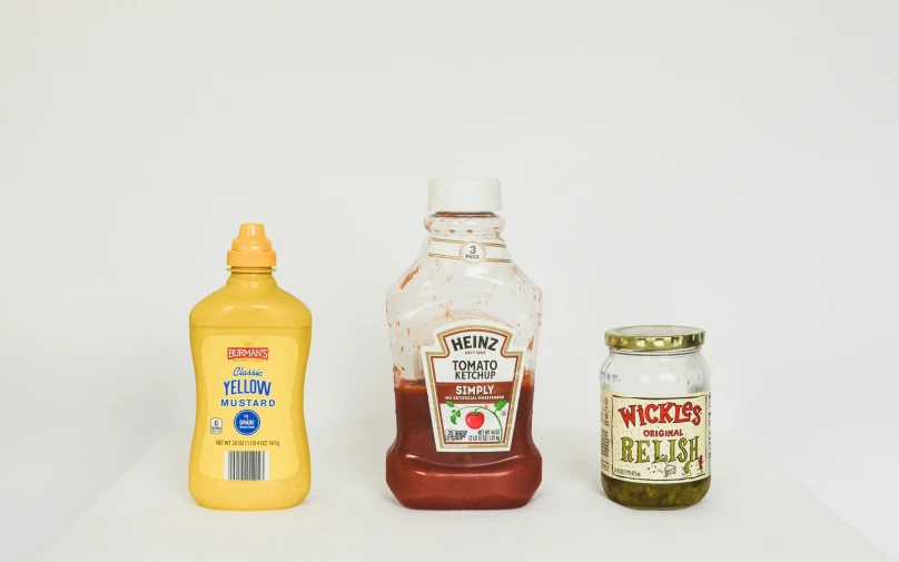 a close up of three different types of condiments