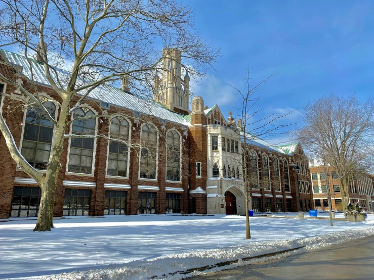 an university building is covered with snow under a blue sky