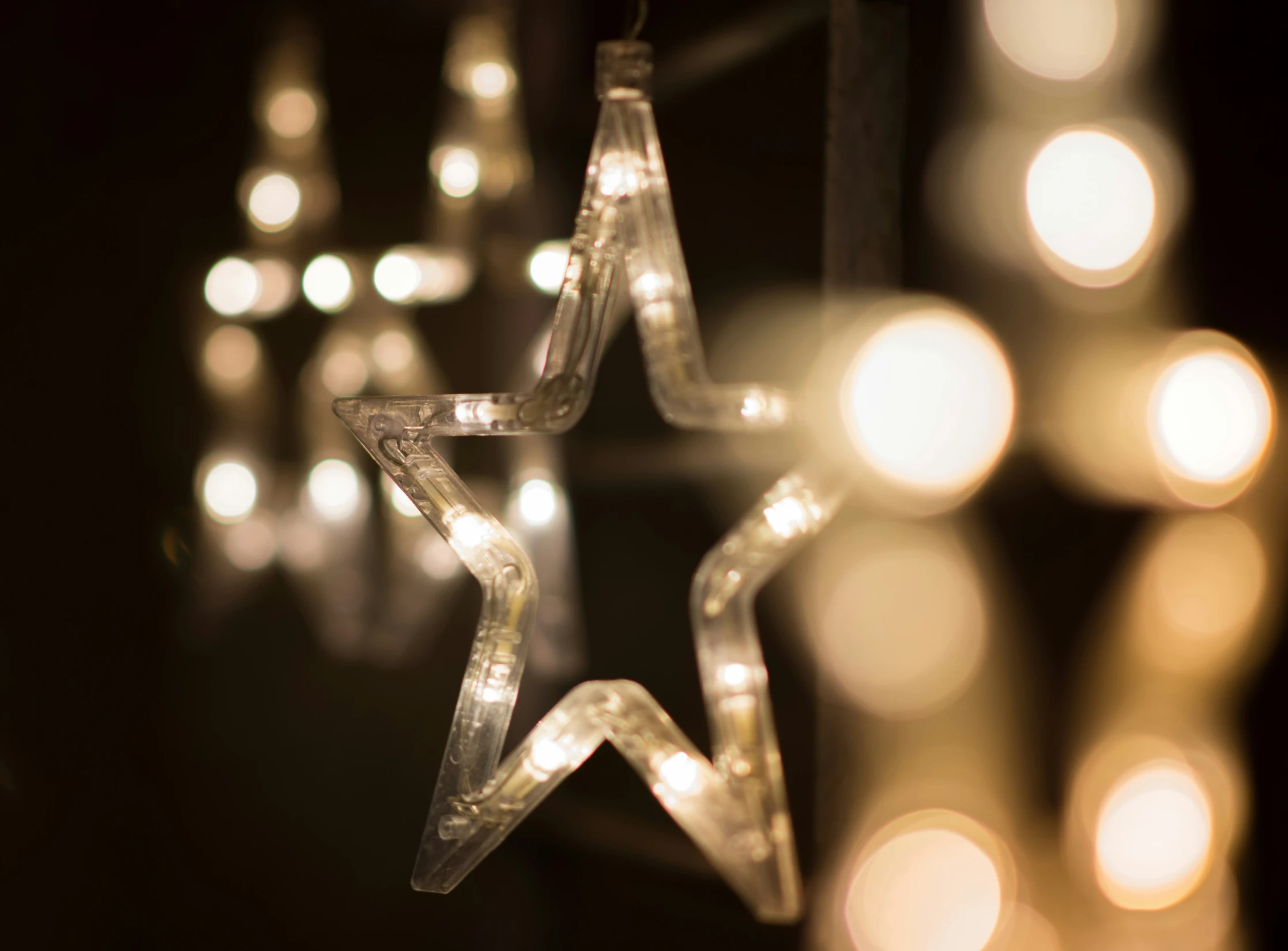 a white star decoration with candles lit in the background