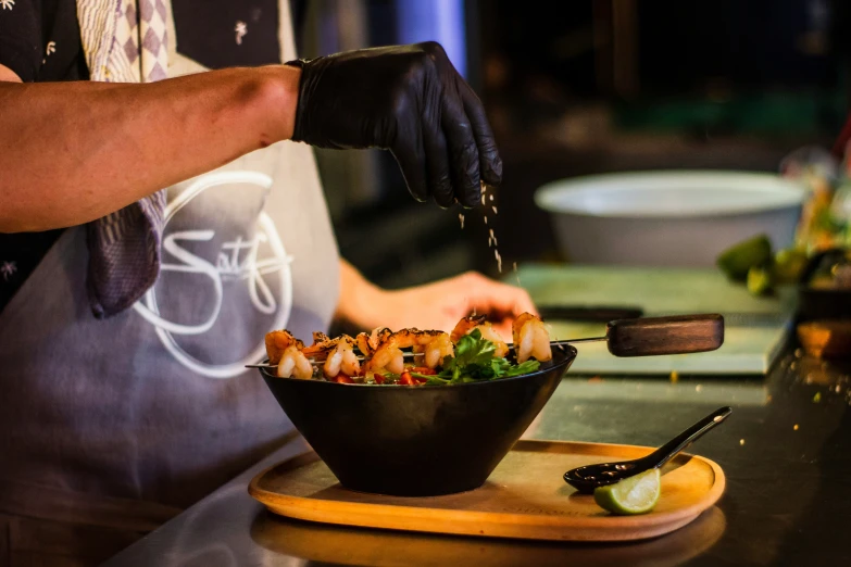 a cook in aprons preparing food on a table