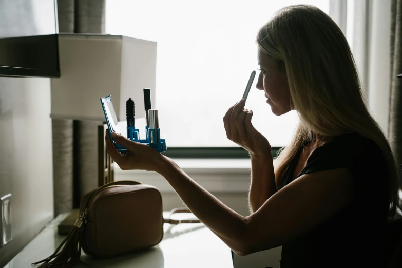 a woman is making an impression as she brushes her teeth