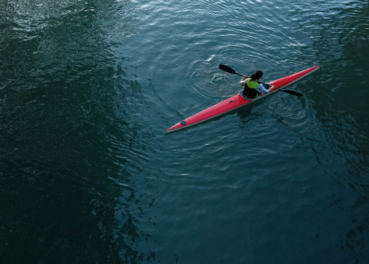 there is a person kayaking alone in the water