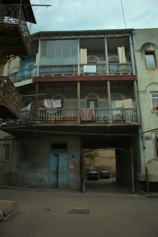 an old building with a car parked on the street