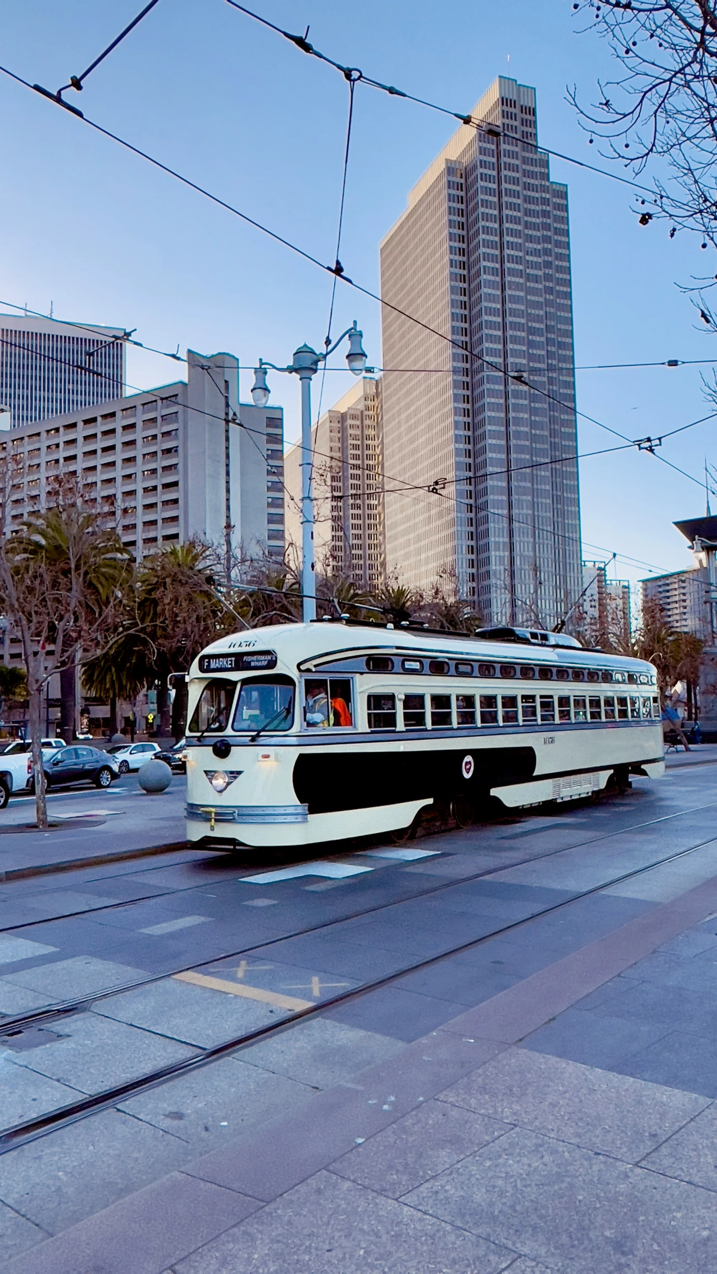 an old bus traveling down the street in front of tall buildings