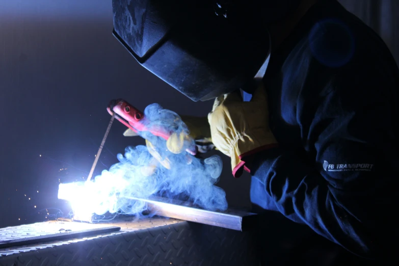 a man in blue work in a machine