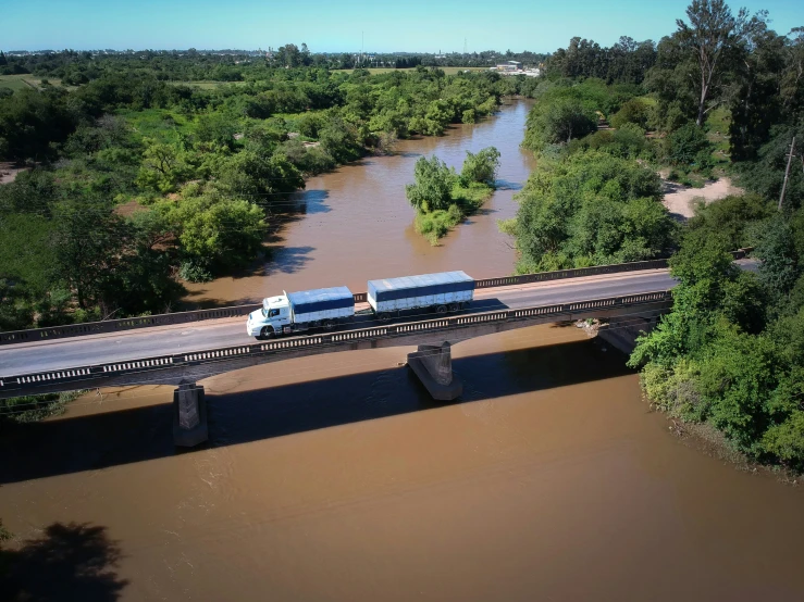 a train is crossing over a bridge over a river