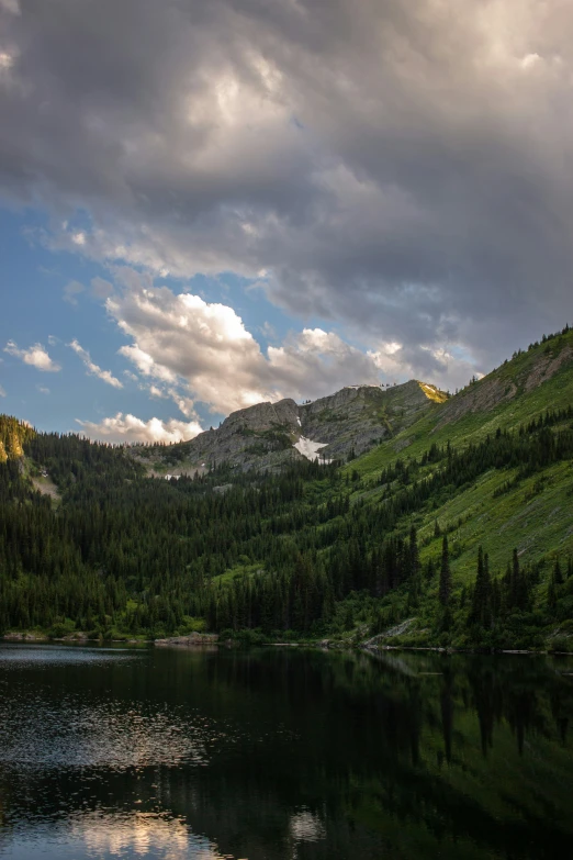 a view of a mountain with a lake next to it