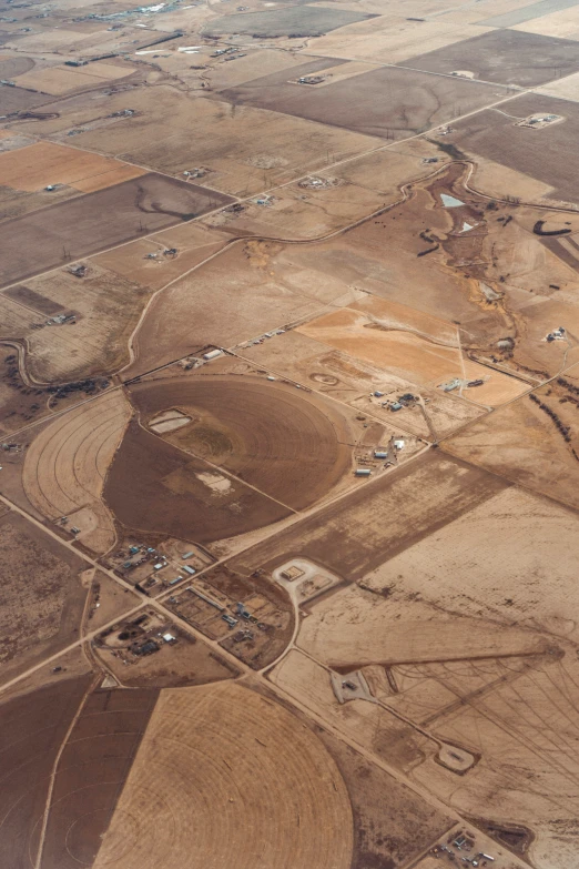 view from an airplane looking down on dirt and land