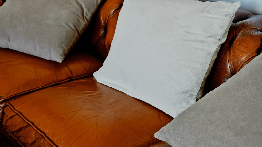 a large couch with five different types of pillows