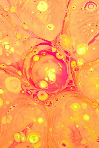 colorful bubbles with yellow centers in yellow fluid