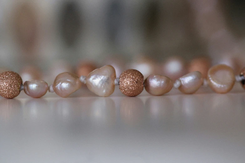 many pearls lined up and scattered around them