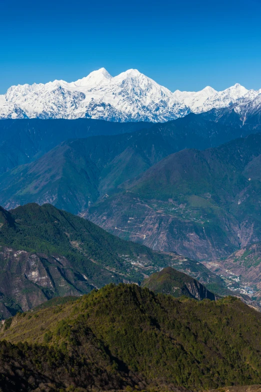 a valley filled with lots of green grass covered mountains