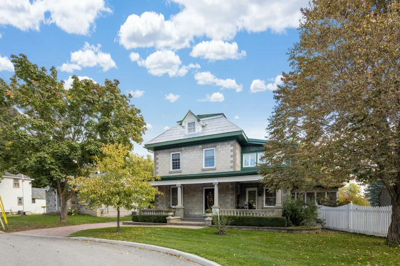 there is a very large two story house with lots of grass