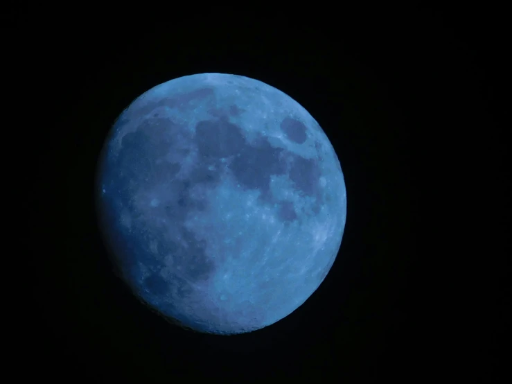 a blue full moon is shining brightly in the sky