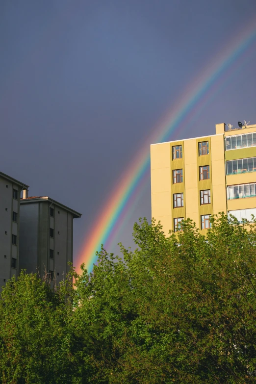 a double rainbow over some apartment buildings