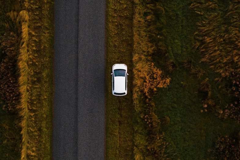 an aerial view of a car on a highway