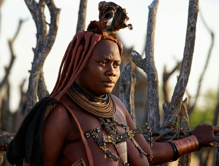 a woman in a costume holds an animal on her head