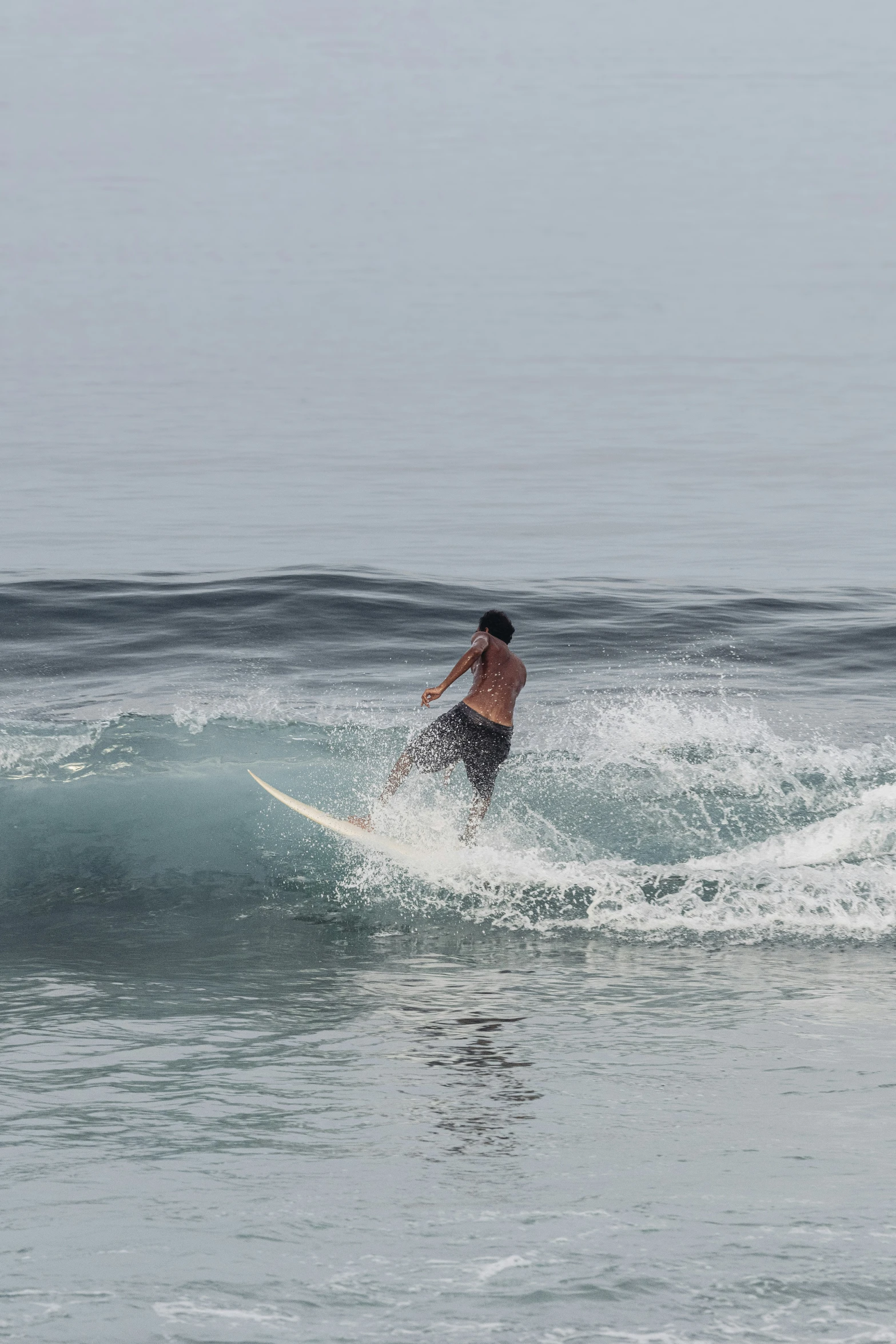 surfer riding a small wave in the ocean