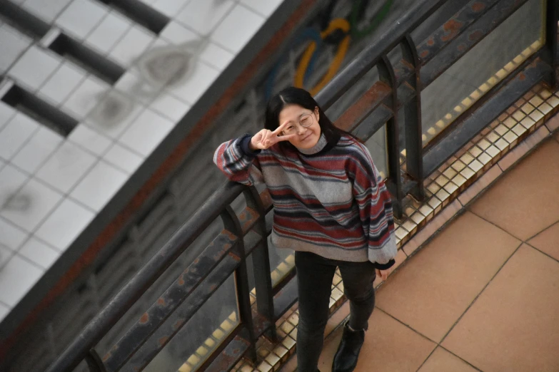 a person standing by a hand rail on stairs