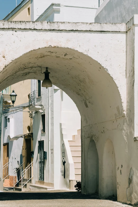 an arch with an outside light at the end