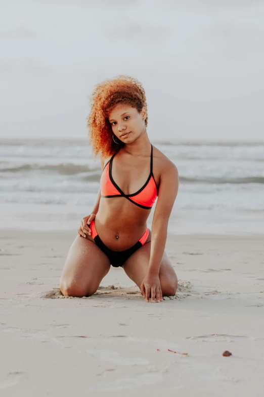 a beautiful woman in a bikini posing on the beach