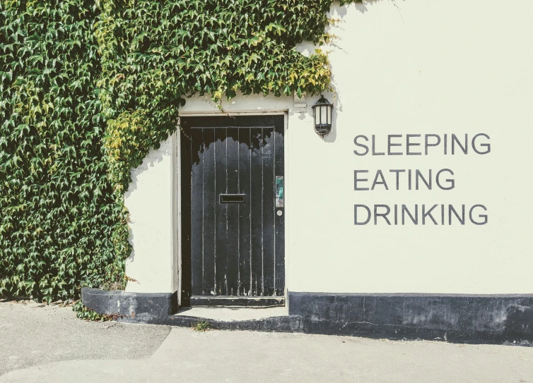 the words sleeping eating drinking are written on a wall