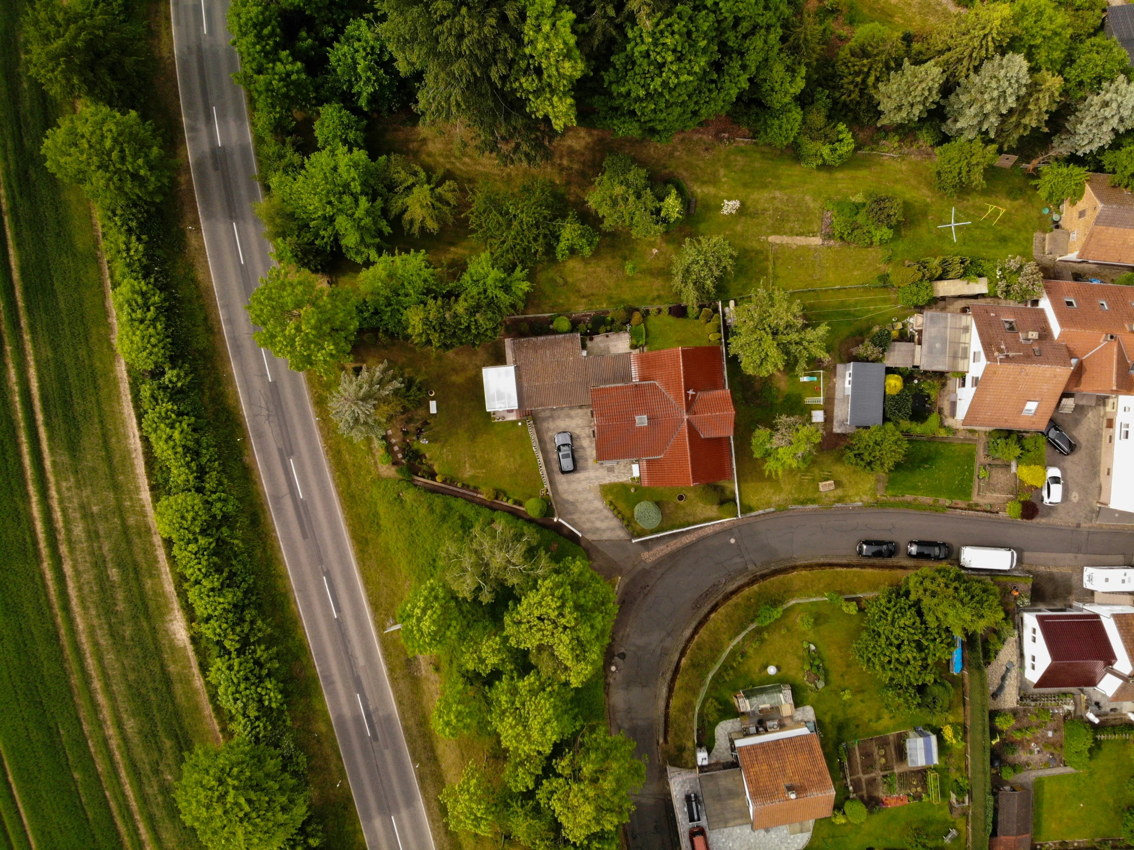 a aerial view of houses near an area that is green