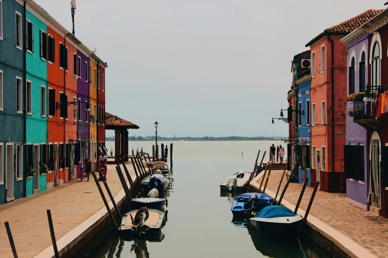 boats on the water in a canal lined with buildings