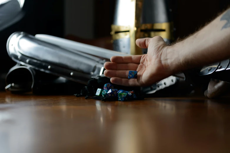 someone is holding the dice from the bottle on the table