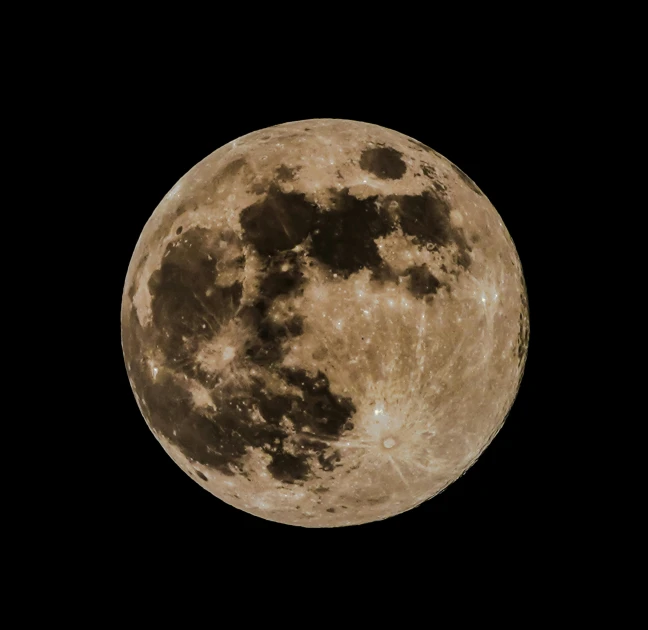 the full moon is bright and a few clouds are seen