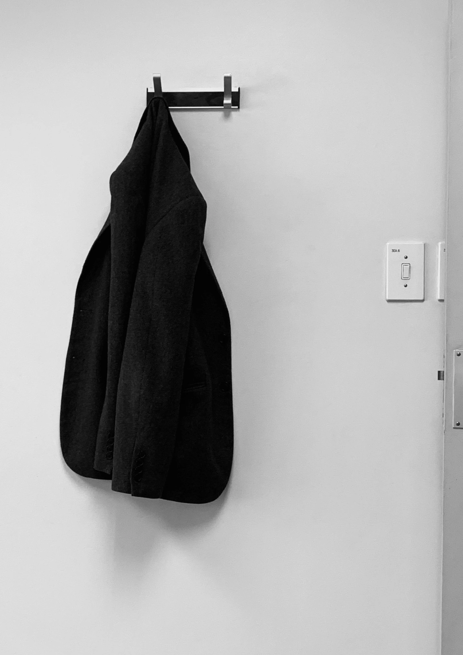 there is a towel and jacket hanging on the wall