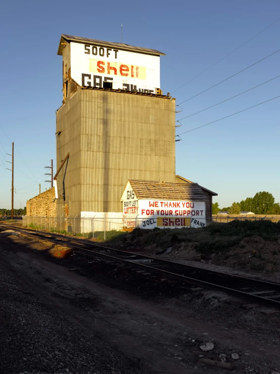 an old grain silo on top of the side of the road