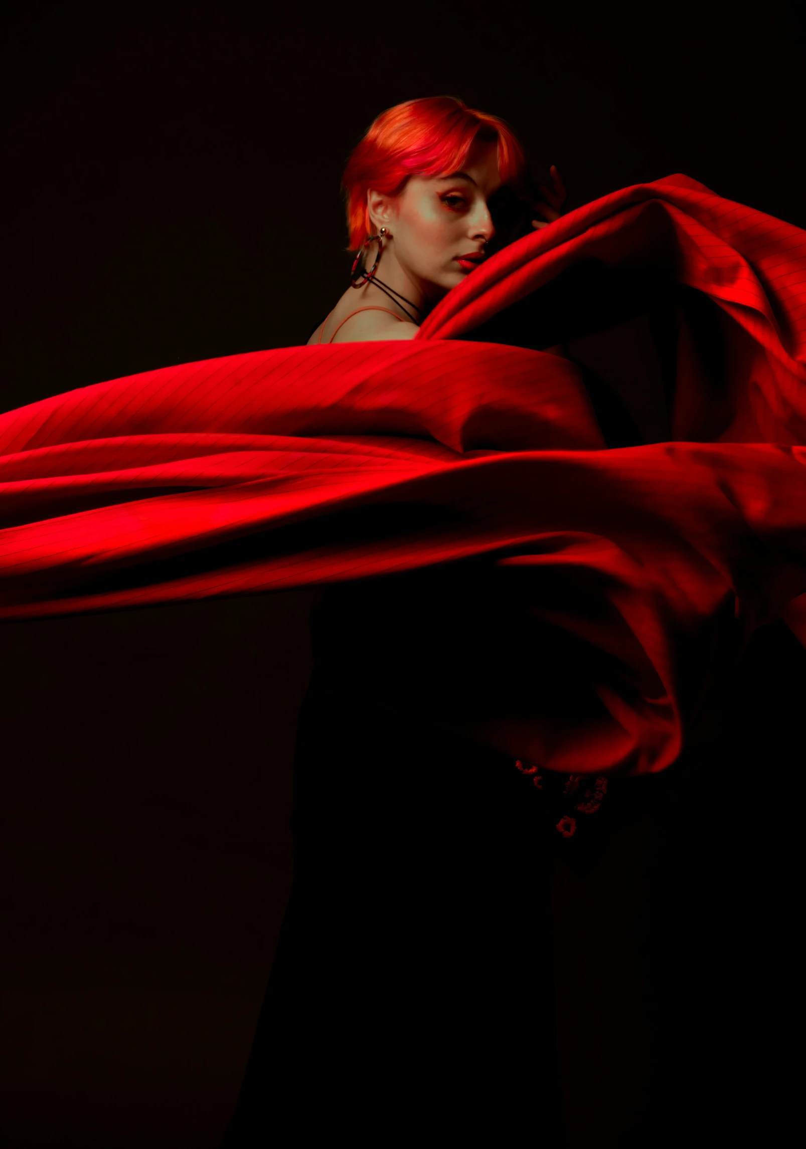 woman in black dress wrapped in red cloth