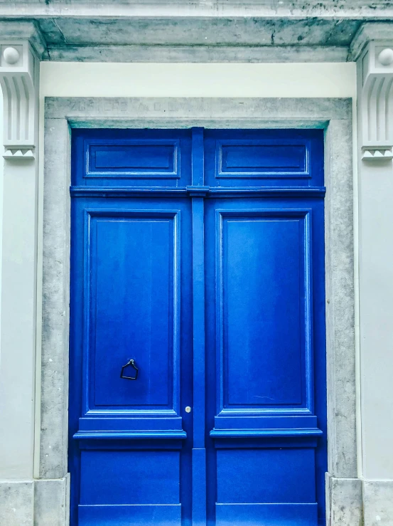 this blue door has ornate carvings on it