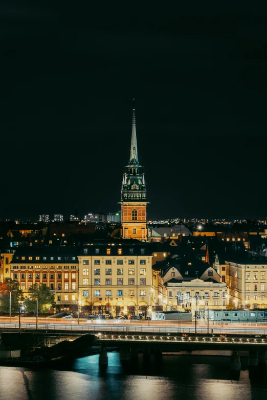 a lit - up city at night with tall buildings