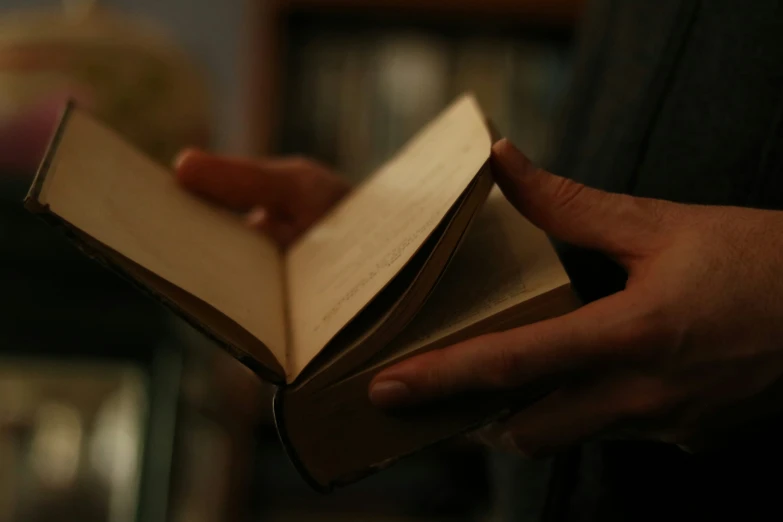 a book with a hand holding it open