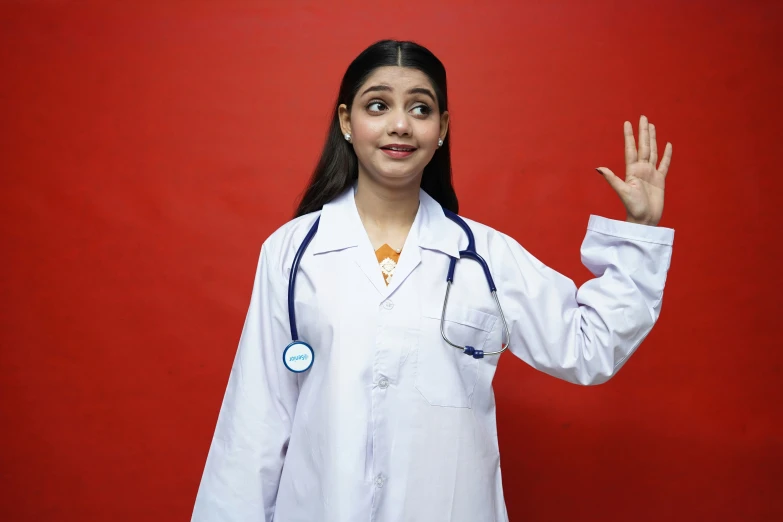 a young female doctor standing and showing the hand signal