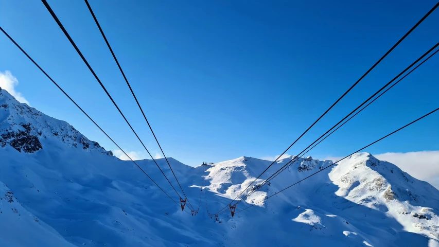 a blue ski slope with snow on the side