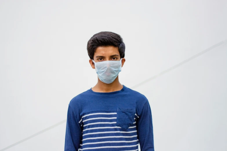 a boy is wearing a face mask to prevent himself from air pollution
