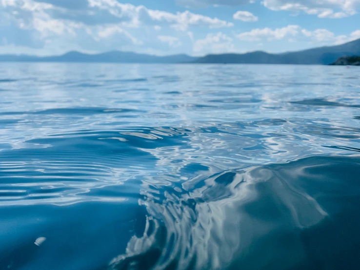 the view of water with mountains in the distance