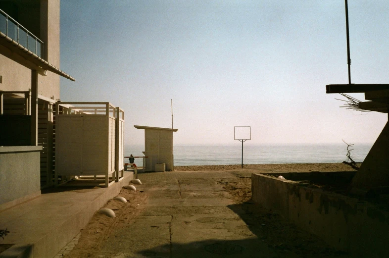 three toilets that are outside near a beach