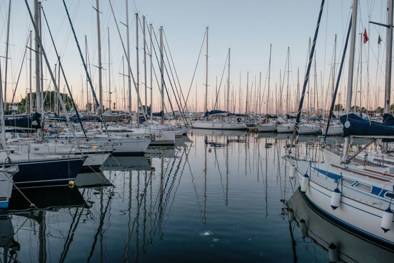 there are many white sailboats sitting in the water