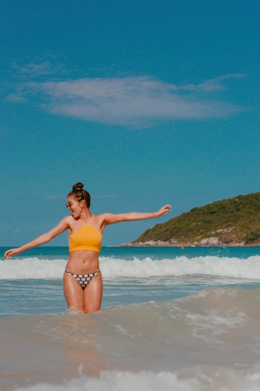 there is a woman in the water at the beach