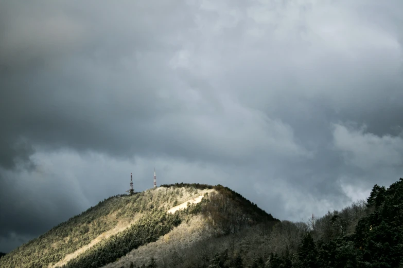 some clouds are in the sky above some hills