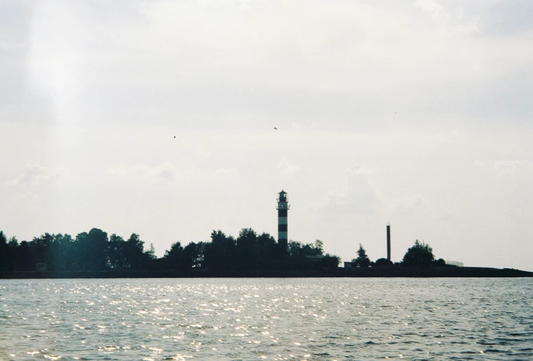 a tall clock tower sitting over a large lake