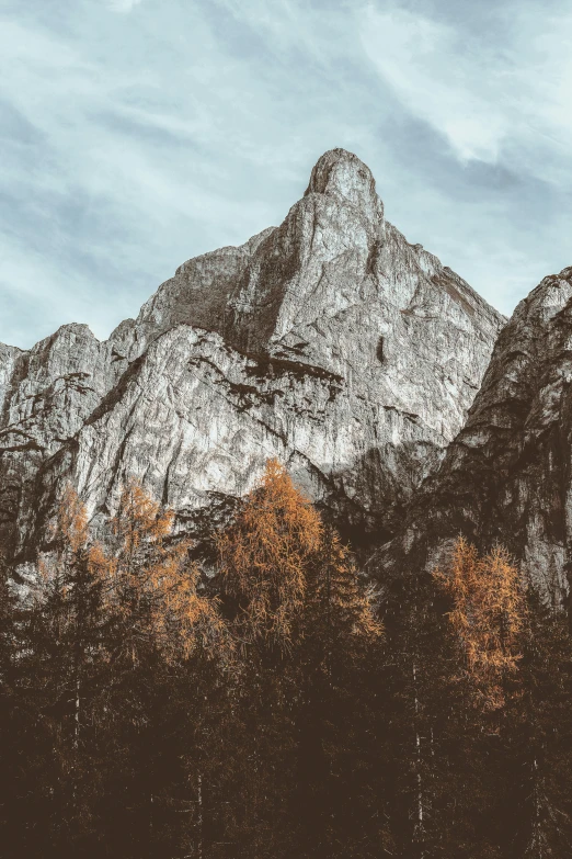 a mountain in the background with white clouds