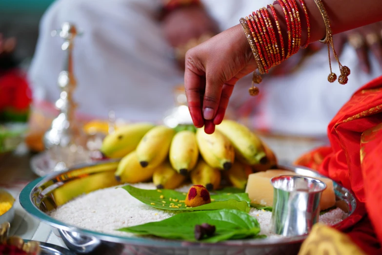 a person decorating a plate with bananas on it