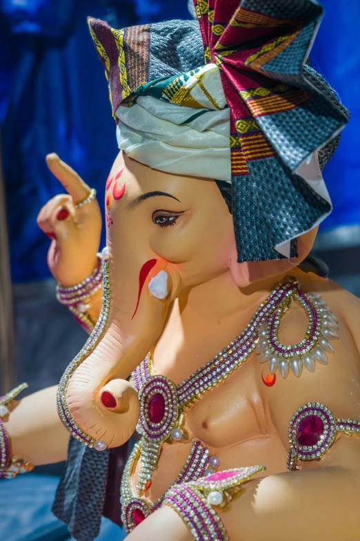 an elephant figurine wearing a headband and jewelled jewelry